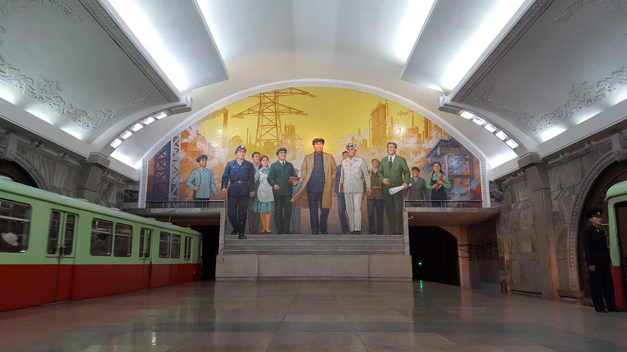 "The Great Leader Kim Il-sung Among Workers" mural in Puhong Station.