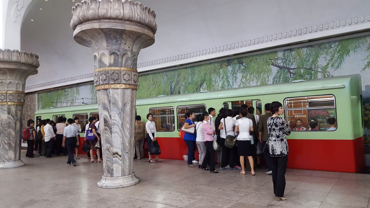 DPRK metro commuters embarking and disembarking.
