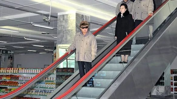 Kim Jong Il in his final public appearance at the Kwangbok Department Store, accompanied by his sister, Kim Kyong-hui, and his son, Kim Jong Un.