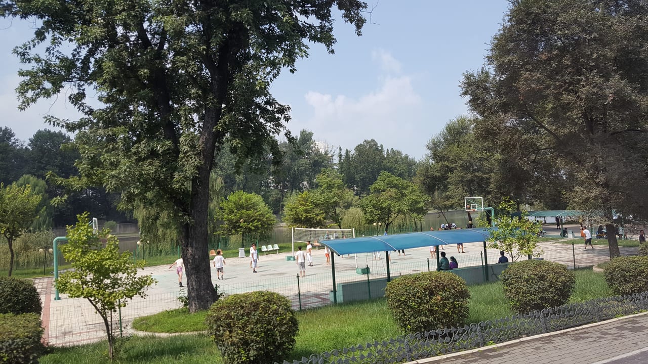 A volleyball and basketball court viewed from our bus. These are popular sports for the country. We saw many and they were always in popular use.