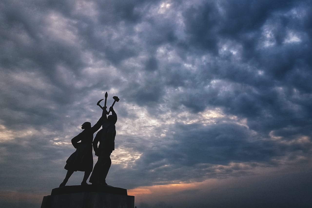 A statue basking in the Pyongyang sunset near the Juche Tower.