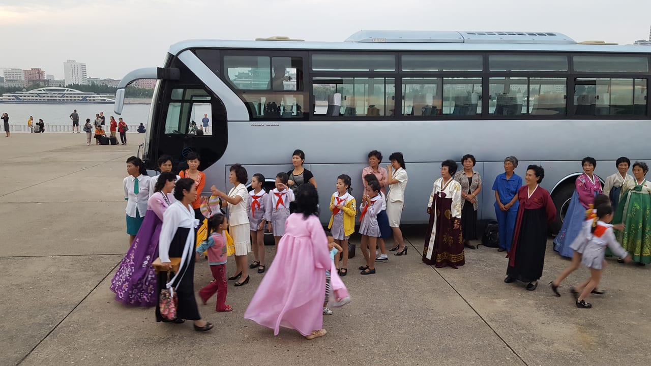 School children and their teachers gathering around the Juche Tower.