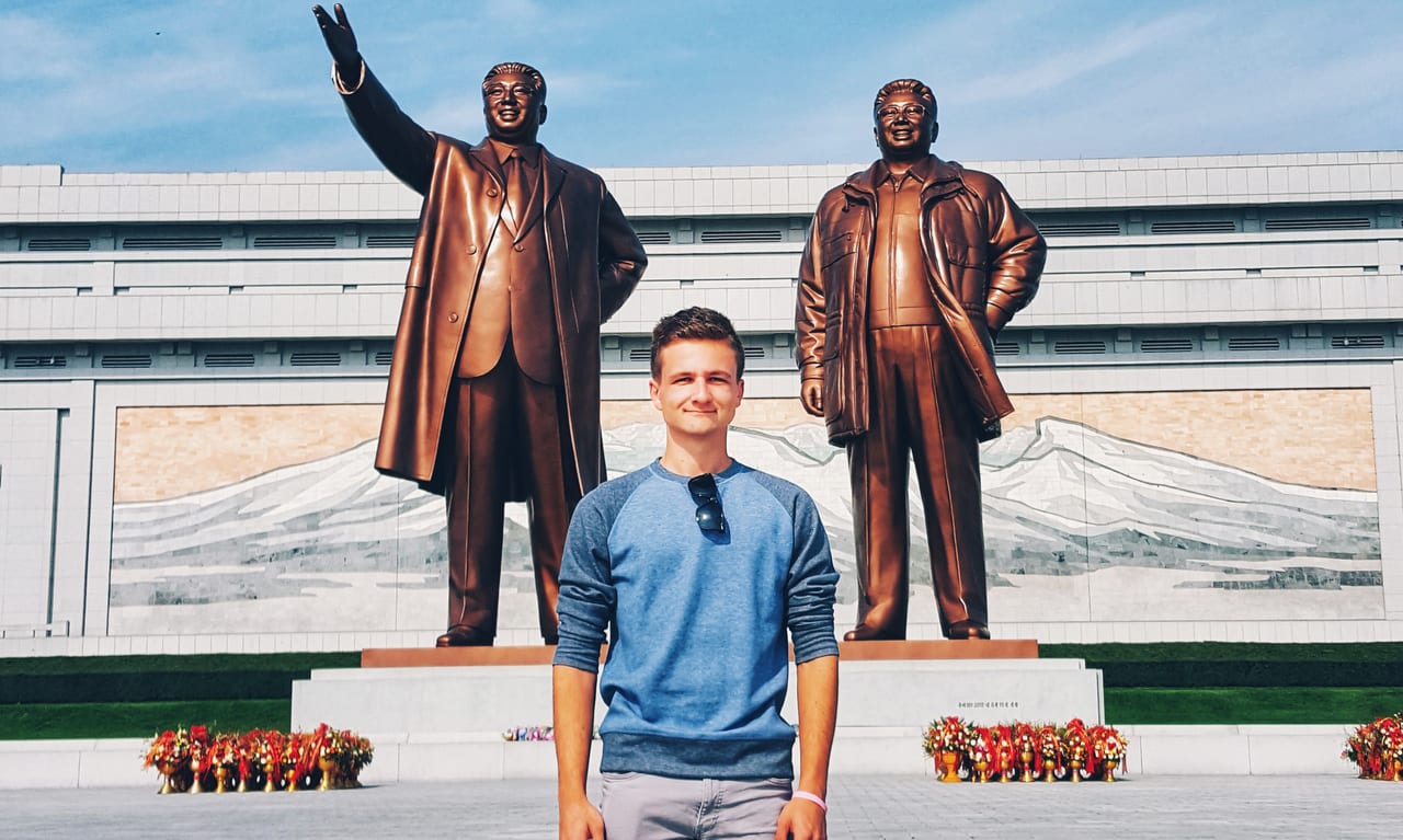 Standing in front of Kim Il Sung and Kim Jong Il statues at the Korean Revolution Museum