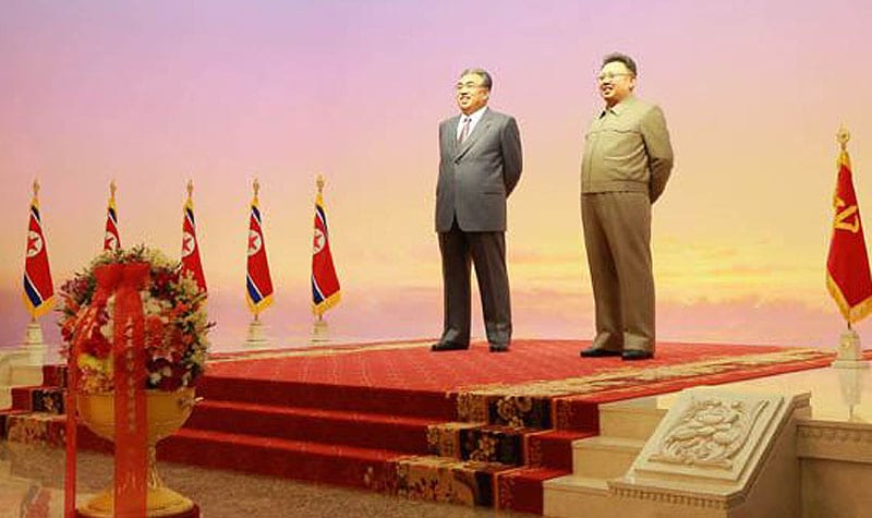 Kim Il Sung and Kim Jong Il welcoming you to their mausoleum.