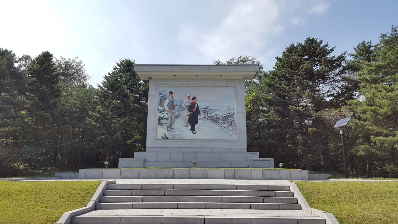 A mural depicting a young Kim Il Sung walking the frozen North Korean countryside.