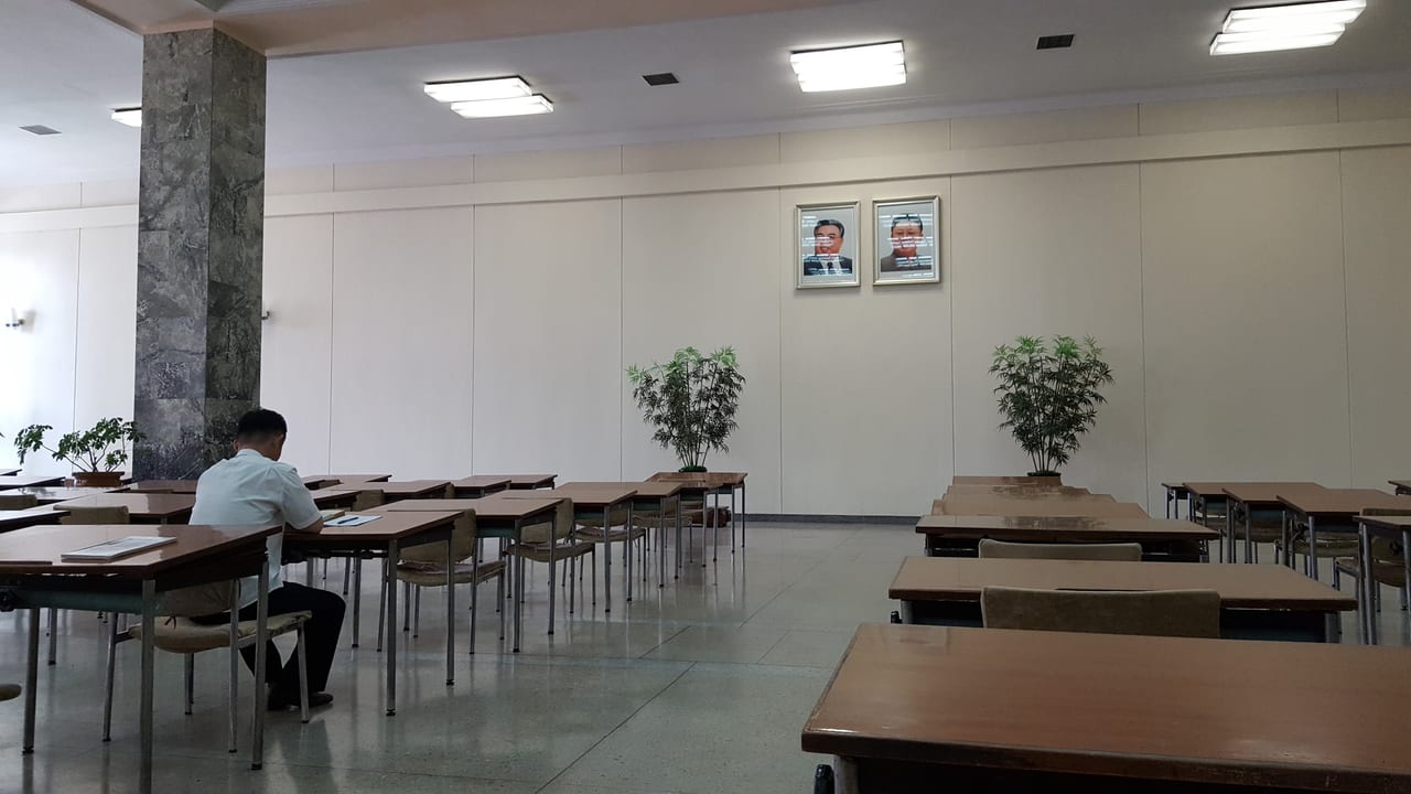 A student in deep study for the leaders at the Grand People's Study House.
