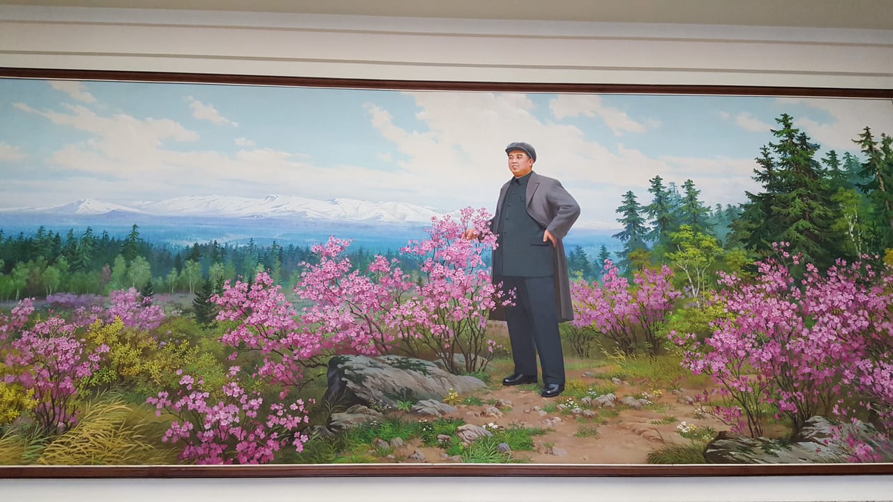 A mural of Kim Il Sung with the beautiful North Korean landscape.